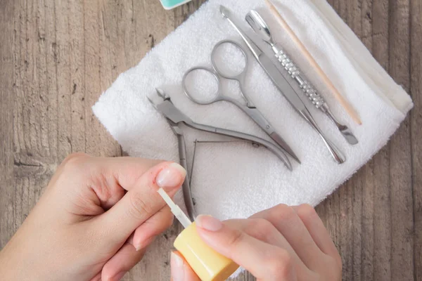 Apply oil to the cuticle. The wound after a manicure. A scratch, a cut. Manicure, nail care. Nail salon, procedure, SPA. Home nail care. Manicure tools. Beauty, lifestyle