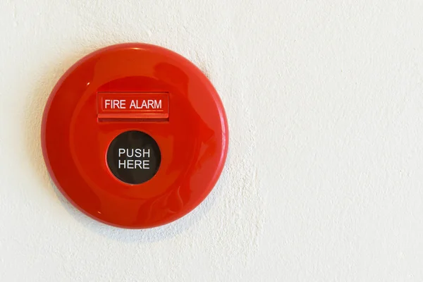 Red fire alarm on a wall