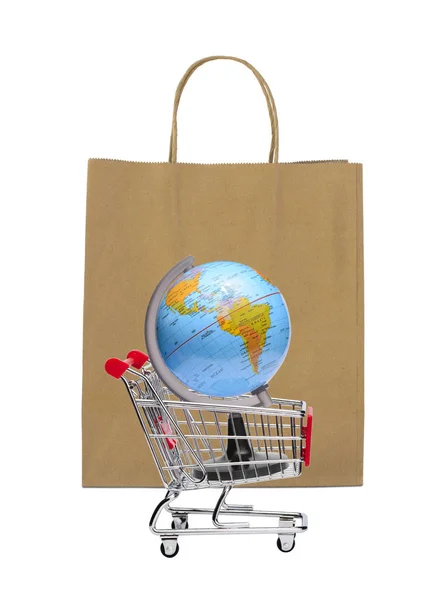 Earth on shopping cart with brown paper bag — Stock Photo, Image