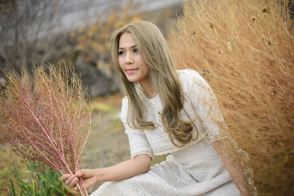 Japanese model posing in autumn field with hay