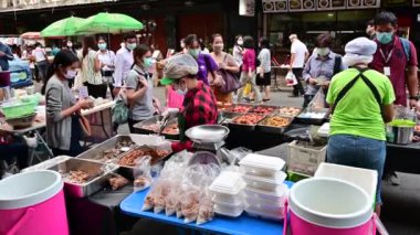 Bangkok, Tayland - 22 Nisan 2020: Taylandlılar Bangkok 'ta karantina sırasında sokak yemeği alırken cerrahi maske takıyorlar