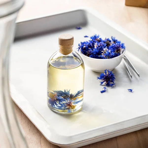 oil for face and body with the colors of cornflower