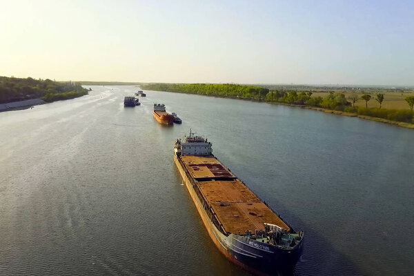 A cargo barge floats along the river. Cargo ship