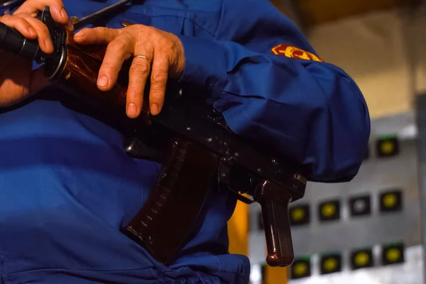 A security guard\'s hand on a Kalashnikov. Armed departmental guards.