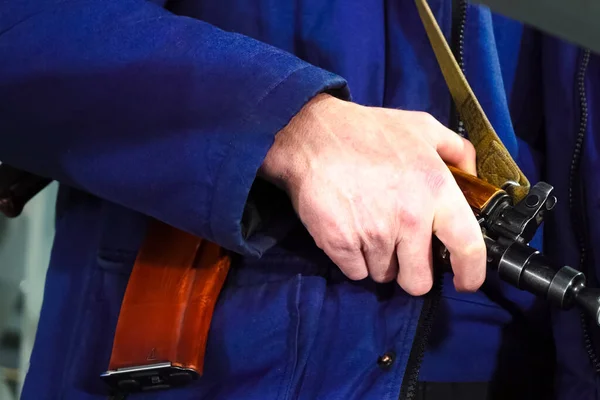 A security guard\'s hand on a Kalashnikov. Armed departmental guards.