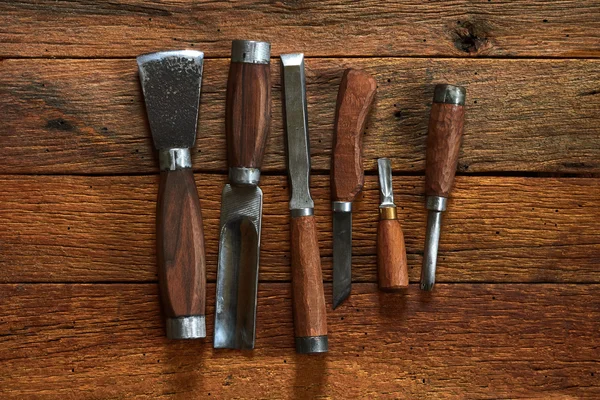 Six chisels  a wooden table Royalty Free Stock Images