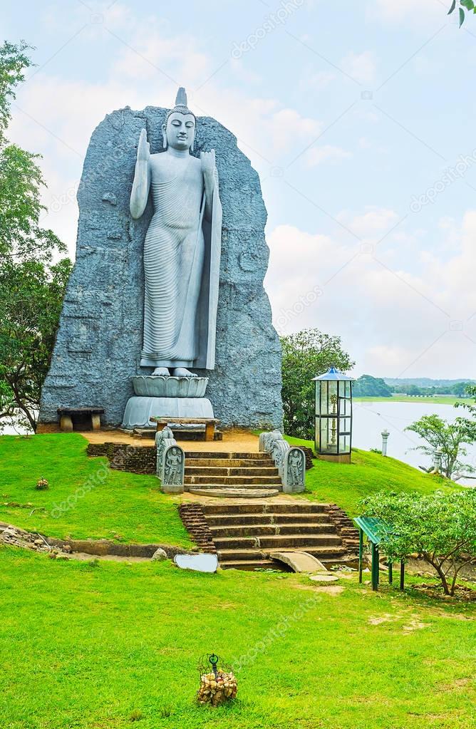 The statue of Buddha at the lake