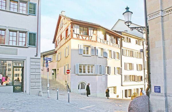 ZURICH, SWITZERLAND - MARCH 20, 2011: The old half-timber houses in historic Kirchgasse street, located on hilly area, on March 20 in Zurich.