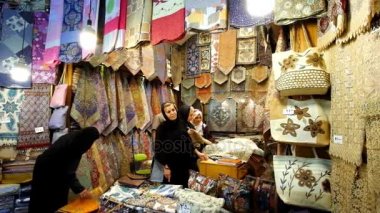 Şiraz, Iran - 14 Ekim 2017: Ziyaretçiler Vakil ın Bazaarı Tekstil deposunun ile masa örtüsü, peçete ve diğer mallar, 14 Ekim'de Shiraz, tığ işi işlemeli Simli Halılar seçin.