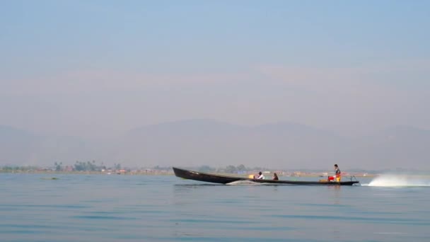 背景には ミャンマーのシャン州の霧山を望むインレー湖に沿ってボートツアーを楽しむ観光客 — ストック動画