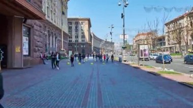 KYIV, UKRAINE - APRIL 14, 2018: Walk along Khreshchatyk Avenue - the central city street, with a view on buildings of the Central Department Store and the City Council (Kievrada), on April 14 in Kyiv.