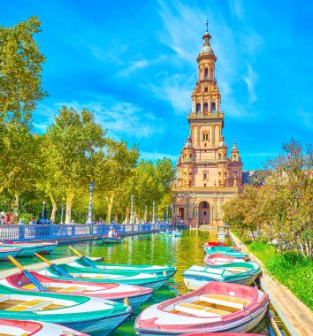 The moored boats on the canal of Plaza de Espana in Seville