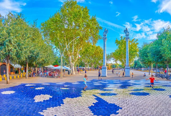 Kins play on large La Alameda sqaure in Seville, Spain