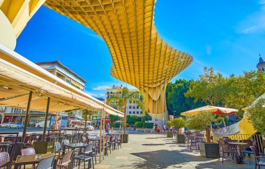 Restaurant under Metropol Parasol construction in Seville, Spain clipart