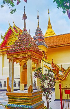 Explore traditional Lanna style buildings of Wat Phra That Doi Suthep, its famous for ornate carved, tile and mirror decors, molding, pyathat roofs, hti finials and sculptures of naga serpents, Chiang Mai, Thailand clipart