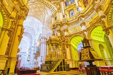 GRANADA, SPAIN - SEPTEMBER 25, 2019: Interior of  Main Chapel (Capilla Major) of Cathedral with arcade, gilt reliefs, stucco decors, paintings and great altar, on September 25 in Granada