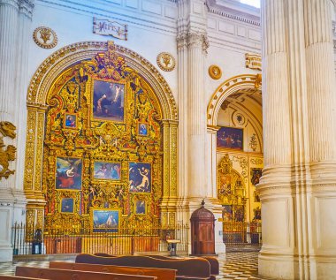 GRANADA, SPAIN - SEPTEMBER 25, 2019: The scenic Altar of Jesus Nazareno (of Nazareth) in Granada Cathedral, decorated with historical paintings and ornate gilt details, on September 25 in Granada