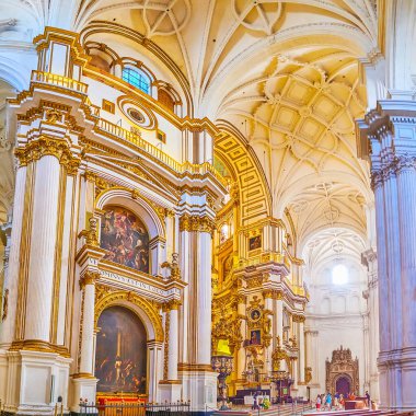 GRANADA, SPAIN - SEPTEMBER 25, 2019: Historical paintings at Capilla Major (Main Chapel) of Incarnation Cathedral, richly decorated with gilt garlands and stucco details, on September 25 in Granada