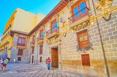 GRANADA, SPAIN - SEPTEMBER 27, 2019: Baroque exterior of Palacio de la Madraza (Madrasah Islamic school), decorated with stone garlands and located in Calle Oficios (La Lonja square), on September 27 in Granada