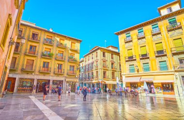 GRANADA, SPAIN - SEPTEMBER 27, 2019: Historical edifices, tourist cafes, stores and souvenir shops in Plaza de las Pasiegas square, on September 27 in Granada