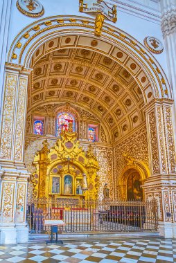 GRANADA, SPAIN - SEPTEMBER 25, 2019: Intricate gilt patterns and carved altarpiece of Capilla (Chapel) de Nuestra Senora del Carmen of Cathedral, on September 25 in Granada