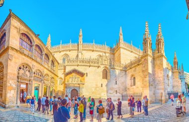 GRANADA, SPAIN - SEPTEMBER 27, 2019: Panorama of the queue in Calle Oficios (La Lonja square) in front of ornate Gothic style Capilla Real (Royal Chapel), on September 27 in Granada