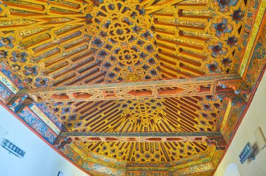 GRANADA, SPAIN - SEPTEMBER 27, 2019: Ornate woodwork on ceiling of the Knigts Hall (Sala de Caballeros) of Palacio de la Madraza (Madrasah), including details of Mudejar style and Christian tradition, on September 27 in Granada