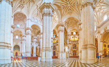 GRANADA, SPAIN - SEPTEMBER 25, 2019: The nave of Incarnation Cathedral with numerous Corinthian columns, carved stucco vault and chapels along the walls, on September 25 in Granada