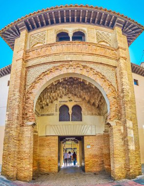 GRANADA, SPAIN - SEPTEMBER 25, 2019: The medieval portal of Corral del Carbon (Coal yard), decorated in Arabic style with mocarabe (muqarnas), relief brick patterns and horseshoe arch, on September 25 in Granada