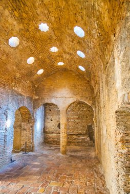 GRANADA, SPAIN - SEPTEMBER 25, 2019: The brick interior of El Banuelo (Arab Baths, hammam) with light holes in vault, on September 25 in Granada