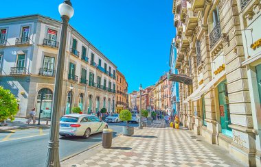 GRANADA, SPAIN - SEPTEMBER 25, 2019: The walk through the fashionable Calle Reyes Catolicos street, full of stores and restaurants, located in historical buildings, on September 25 in Granada