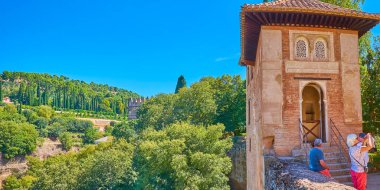 GRANADA, SPAIN - SEPTEMBER 25, 2019: Panorama of medieval Partal chapel (oratorio) with lush greenery of Generalife gardens of Alhambra on the background, on September 25 in Granada clipart