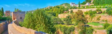 Panorama from Alhambra rampart with a view on towers and Sun Hill (Cerro del Sol) with ornamental Generalife gardens, Granada, Spain clipart