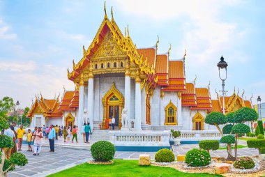 BANGKOK, THAILAND - MAY 13, 2019: The ornamental garden around the Ubosot (Ordination Hall) of Wat Benchamabophit Dusitvanaram Marble Temple, on May 13 in Bangkok clipart