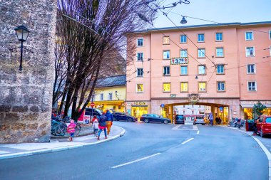SALZBURG, AUSTRIA - 1 Mart 2019: Meşgul Burgerspitalplatz karesi, tarihi binanın büyük zırhlı geçidi, 1 Mart 'ta Salzburg' da
