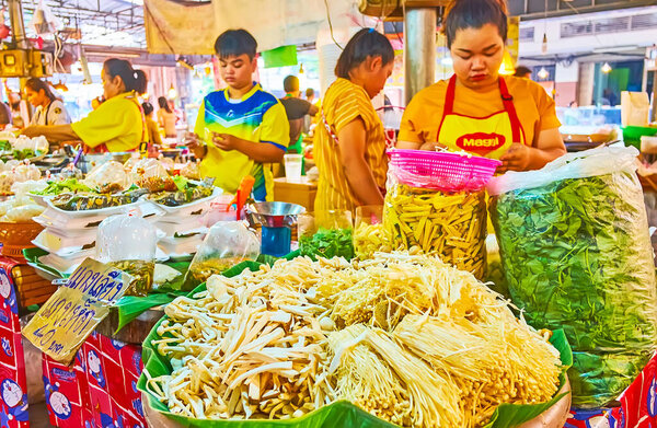 BANGKOK, THAILAND - MAY 13, 2019: The dish with heaps of enoki mushrooms (enokitake, golden needle) in stall of Talad Saphan Phut market, on May 13 in Bangkok