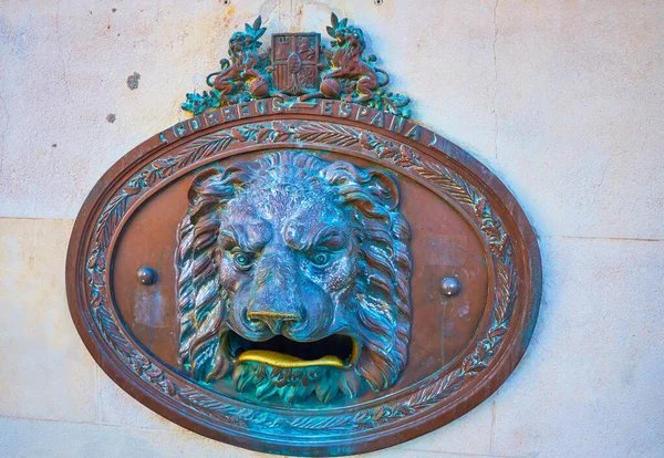 The scenic bronze lion-head post box with open mouth for correspondence, located on the wall of post office, Cadiz, Spain
