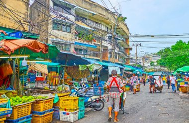 BANGKOK, THAILAND - 13 Mayıs 2019: Mahanak Meyve Pazarı 'nın işlek caddesi, taze meyve ve hamallar sunuyor, el arabalarıyla yürüyor, mallarla yüklü, 13 Mayıs' ta Bangkok 'ta