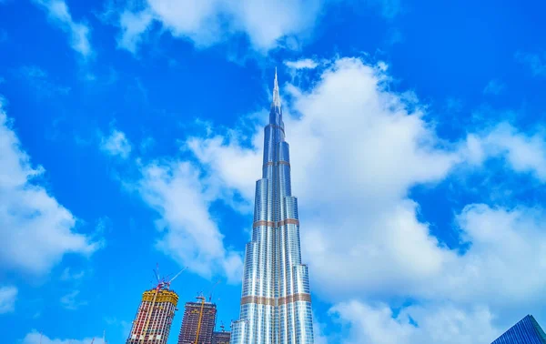 The magnificent Burj Khalifa, the tallest building in the world cutting clouds with its spire, Dubai, UAE
