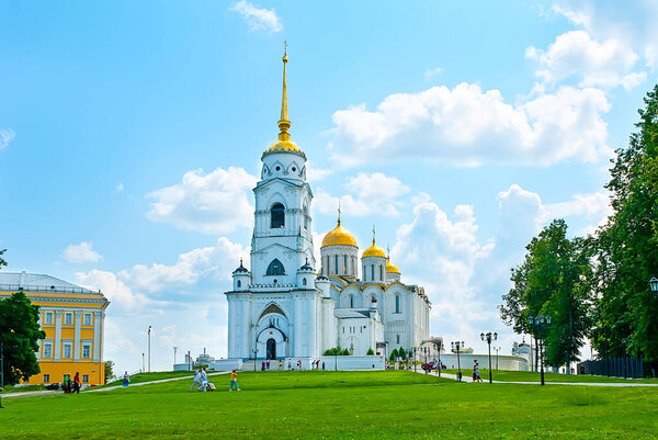 VLADIMIR, RUSSIA - JUNE 30, 2013: The facade of Dormition Cathedral with lofty bell tower, topped with golden spire, on June 30 in Vladimir