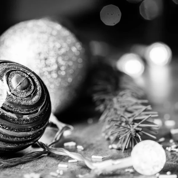 Black and white Christmas background with baubles, fir and fairy