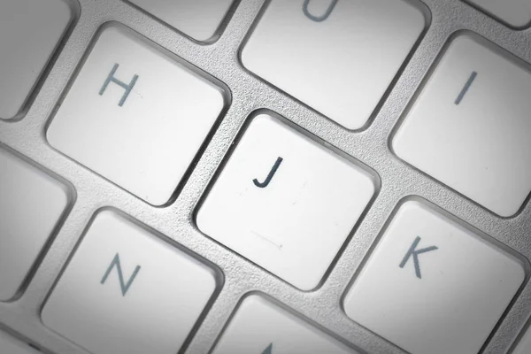 Computer keyboard - silver keyboard of a laptop with button J is — Stock Photo, Image