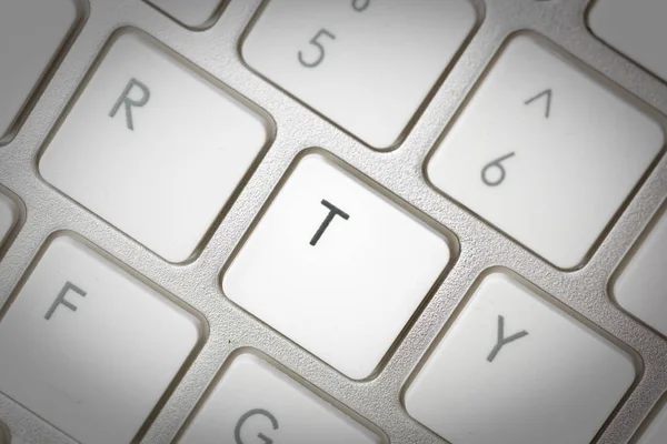 Computer keyboard - silver keyboard of a laptop with button T is — Stock Photo, Image