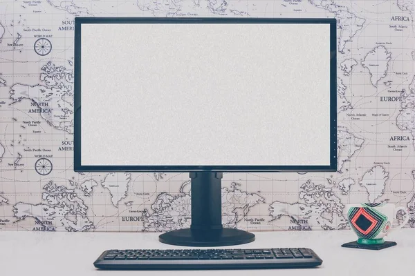 Blank computer desktop with keyboard and coffee mug on white tab