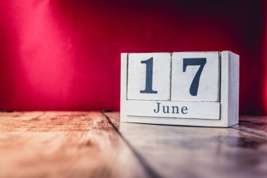 17 Haziran. Ayın 17 'si, iş yerindeki çalışma masasının takvimi, canlı kırmızı arka planlı iş yeri. Yaz zamanı.