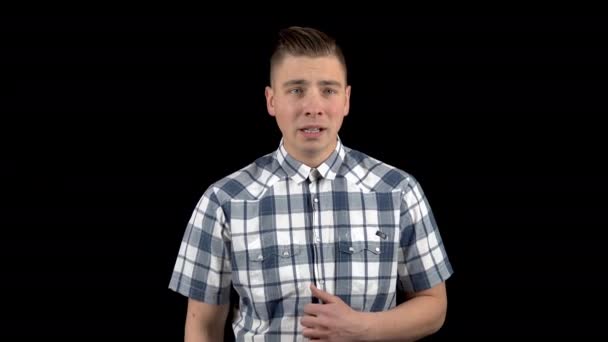Ein junger Mann zeigt ein Gefühl der Angst im Gesicht. Ein Mensch erlebt Angst. ein Mann im Hemd auf schwarzem Hintergrund — Stockvideo