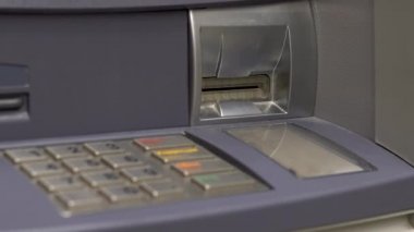 ATM close-up. ATM for cash withdrawal and deposit. The card entry slot blinks.