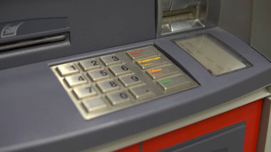 ATM close-up. ATM for cash withdrawal and deposit. The card entry slot blinks.