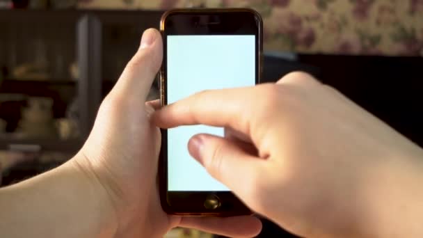 The man uses the phone. Hand makes swipe left on smartphone with white screen. Template. — Stock Video