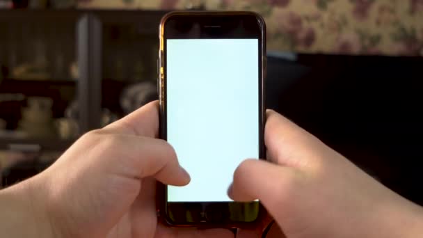 The man uses the phone. Hands is typing on smartphone with white screen. Template. — Stock Video